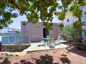 a patio with a table and chairs in front of a building at Elafonisi Paradise with Parking, WiFi, - Walking Distance to the Beach in Elafonisi