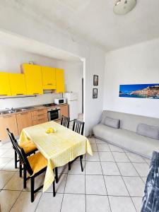 a kitchen and dining room with a table and a couch at Narissara apartment in La Spezia