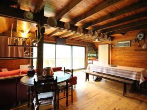 a dining room with a table and a bed at Mont-Dore: Chalet 3 chambres, parking, terrasse, proche pistes - FR-1-415-57 in Le Mont-Dore +9 photos