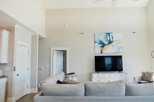 a living room with two couches and a tv at Family Tides North Topsail Beach in North Topsail Beach +138 photos