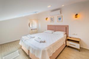 a bedroom with a bed with two towels on it at Blue View Suites Kaş in Kas