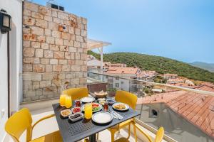 a table with food on top of a balcony at Blue View Suites Kaş in Kas