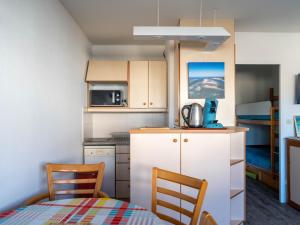 a small kitchen with a table and two chairs at Studio Arcachon, 1 pièce, 3 personnes - FR-1-319-547 in Arcachon