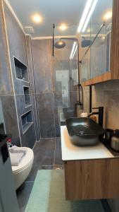 a bathroom with a black sink and a shower at George luxury living in Preveza +93 photos