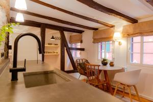a kitchen with a sink and a table with chairs at N1Quartier in Bad Münstereifel