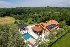 an overhead view of a house with solar panels on its roof at Villa Pendolina with Private Pool in Buje
