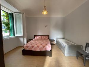 a bedroom with a bed and a bench in it at Casa al mare in Savona
