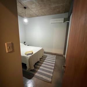 a bedroom with a white bed in a room at El olivo departamentos in San Salvador de Jujuy +22 photos