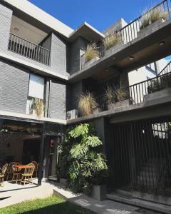 an apartment building with plants on the balconies at El olivo departamentos in San Salvador de Jujuy