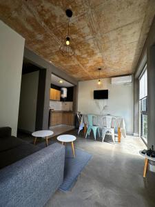 a living room with a couch and a table and chairs at El olivo departamentos in San Salvador de Jujuy