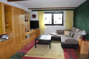 a living room with a couch and a table at Ferienscheune Sächsische Schweiz in Lichtenhain +7 photos