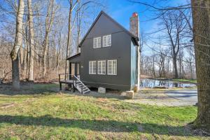 a small gray house in the middle of a yard at The Roundtop Chalet romantic couples getaway in Wrightsville