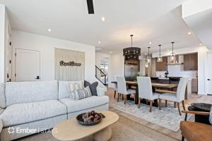 a living room with a couch and a dining room at Desert Dream at Desert Color (by Ember Stays) in St. George
