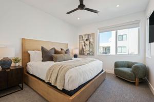 a bedroom with a bed and a chair and a window at Desert Dream at Desert Color (by Ember Stays) in St. George +55 photos