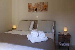 a bedroom with two towels on a bed at Apartment Lucia in Argostoli