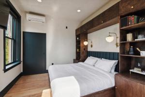 a bedroom with a bed and a book shelf at Society Hill Hotel in Philadelphia