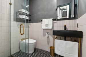 a bathroom with a toilet and a glass shower at Society Hill Hotel in Philadelphia