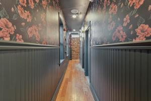 a hallway with black and pink floral wallpaper at Society Hill Hotel in Philadelphia