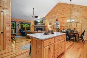 a kitchen and living room of a log cabin at Large Cabin to Enjoy in Coosawattee River Resort in Ellijay