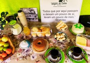 una mesa con un montón de comida y bebidas en Pousada Rural Vargem do Cedro, en Belo Vale