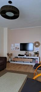 a living room with a flat screen tv on a wall at Relax Apartament in Constanţa