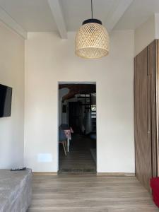 a living room with a pendant light and a hallway at Maison Du Bois in Rivarolo Canavese
