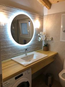 a bathroom with a sink and a mirror at Casa Ortensia in Kato Korakiana +20 photos