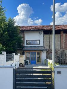 a house with a blue door and some stairs at Maison Du Bois in Rivarolo Canavese