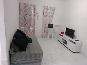 a small living room with a couch and a television at Ap01-A 50 Metros da Praia Flats Mobiliados para 4 Pessoas in Paulista +11 photos