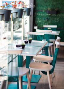 a glass table and chairs in a restaurant at La Onda Hotel Durres in Durrës