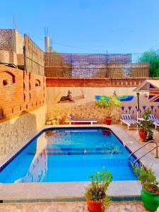 a swimming pool in the middle of a building at Moonlight Home in Luxor
