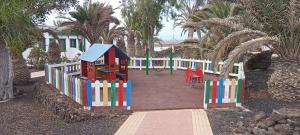 a playground with a colorful building and a play yard at Casa Gioeli Cocosol in Costa de Antigua