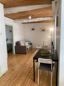 a living room with a table and a couch at Casa da Lurdinhas in Tabuaço