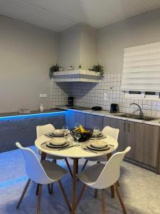 a kitchen with a table and chairs in a kitchen at Sunny house in Kremasti