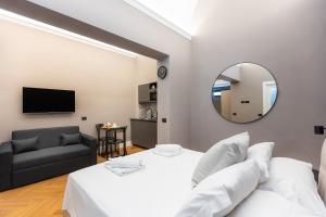 1 dormitorio con cama, espejo y sofá en Luxury Suite Trevi, en Roma 30 fotos más