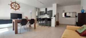 a kitchen and living room with a table and chairs at Appartamento con posteggio privato in Portovenere