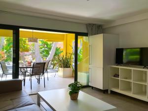 a living room with a television and a table at B-Rent Atlantic Garden 181 in Corralejo