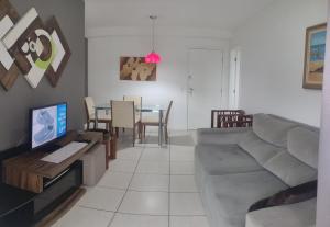 a living room with a couch and a table at Barra Rio Centro in Rio de Janeiro