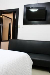 En eller flere senger på et rom på Hotel Presidente Internacional