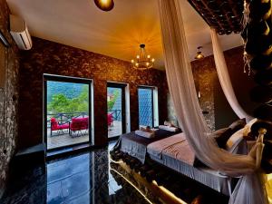 a bedroom with a hammock bed in a room with a balcony at Qafqaz Modern Bungalow in Gabala +90 photos