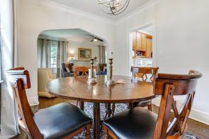 a kitchen and dining room with a wooden table and chairs at Minneapolis Vacation Rental about 5 Mi to Downtown! in Minneapolis
