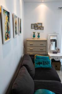 a living room with a couch and a dresser at Central cozy apt in quiet area in Engomi in Nicosia