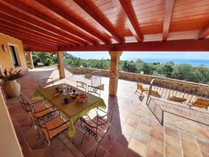 einen Blick über eine Terrasse mit einem Tisch und Stühlen in der Unterkunft Villa Caldinelli in Muravera