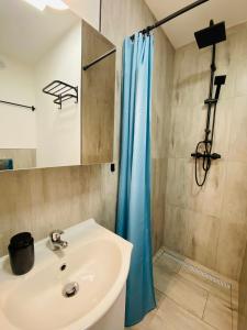 a bathroom with a sink and a shower at 36-Maniana - DeerRest Apart in Jelenia Góra