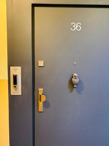 a blue door with the number on it at 36-Maniana - DeerRest Apart in Jelenia Góra
