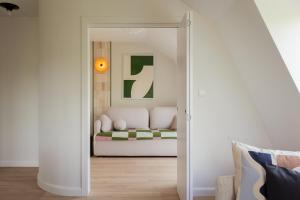 a living room with a couch through a doorway at Sopot M17 - by JWPM in Sopot