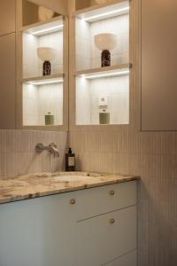 a bathroom with a sink and two mirrors at Sopot M17 - by JWPM in Sopot +23 photos