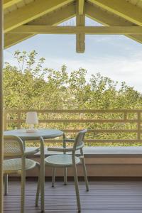 a table and chairs on a porch with a window at Sopot M17 - by JWPM in Sopot