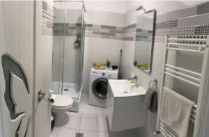 a bathroom with a sink and a toilet and a shower at Luxury Apartments Mall V in Bacău +16 photos