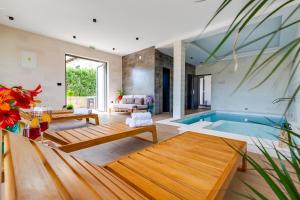a living room with a swimming pool and a house at Terra Maiorum -12 person private Villa - heated pool and water massage in Povljana +37 photos